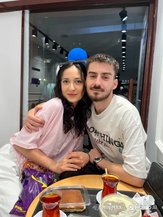 Family's Joyful Embrace in a Cozy Cafe – AI Generated Video | Hailuo AI