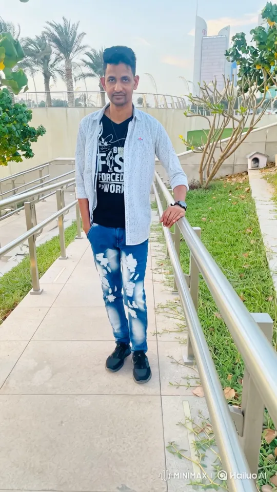 Man in Graphic T-Shirt Smiles at Camera in Urban Park – AI Generated Video | Hailuo AI