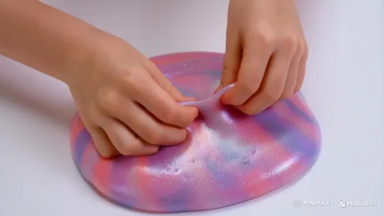 Close-up of Hands Playfully Shaping Sparkling Slime – AI Generated Video | Hailuo AI