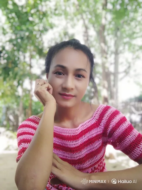 Woman Appreciates Blossoms in Serene Outdoor Scene – AI Generated Video | Hailuo AI