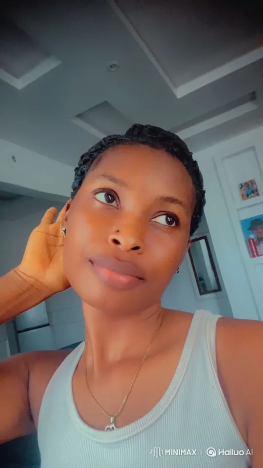 Young Woman's Subtle Smile in Intimate Indoor Setting – AI Generated Video | Hailuo AI