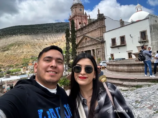 Family of Three Shares Loving Moment in Sunlit Town Square – AI Generated Video | Hailuo AI