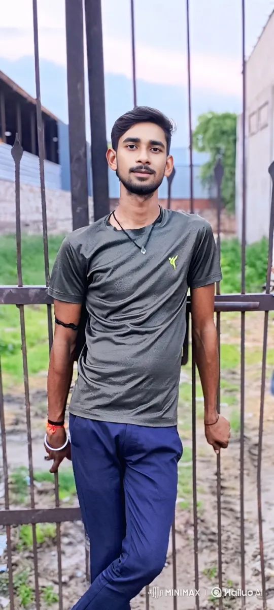 Young Man at Metal Gate: A Study in Serenity – AI Generated Video | Hailuo AI