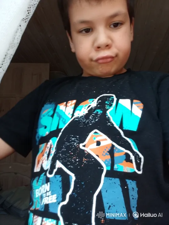 Young Boy in Thoughtful Pout, Focused on Graphic Tee – AI Generated Video | Hailuo AI