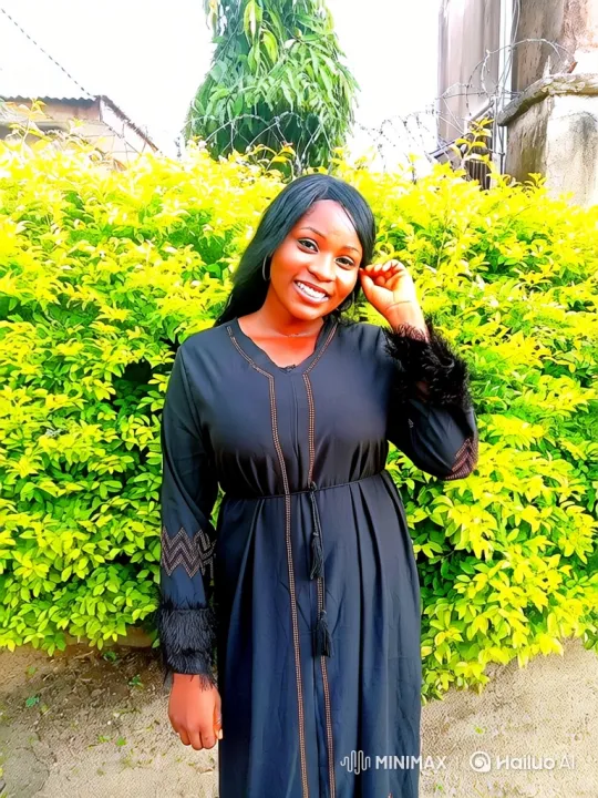 Cheerful Woman in Black Dress Amidst Greenery – AI Generated Video | Hailuo AI