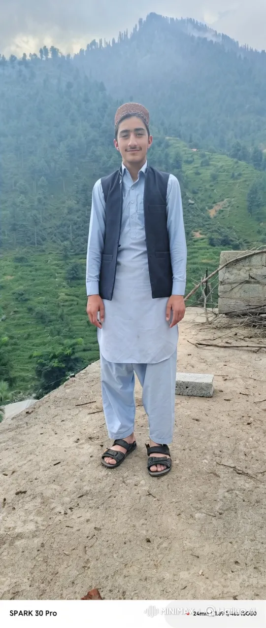 Young Man on Mountain Rock Amidst Gentle Breeze – AI Generated Video | Hailuo AI