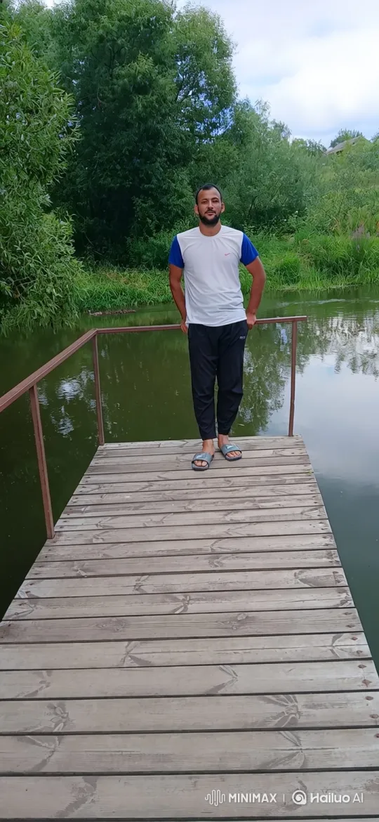 Man on Dock Reflects Calmly Amidst Nature's Beauty – AI Generated Video | Hailuo AI