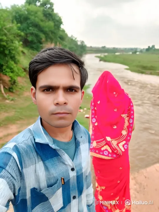 Couple Takes Selfie by Scenic River with Tracking Shot – AI Generated Video | Hailuo AI