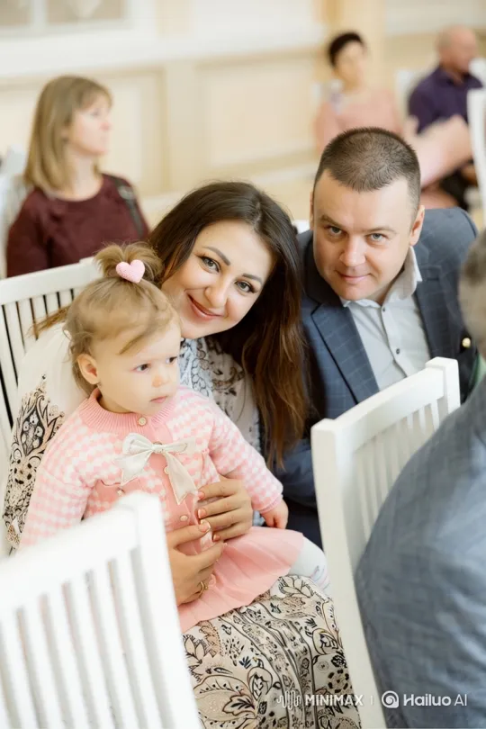 Young Family Shares Intimate Moment at Indoor Event – AI Generated Video | Hailuo AI