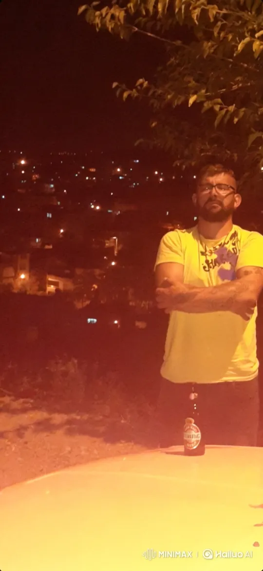 Bearded Man Reflects on Cityscape at Night – AI Generated Video | Hailuo AI