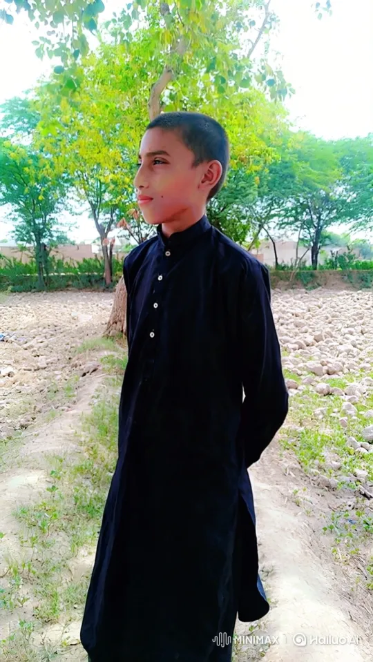 Contemplative Boy in Natural Setting with Gentle Breeze – AI Generated Video | Hailuo AI