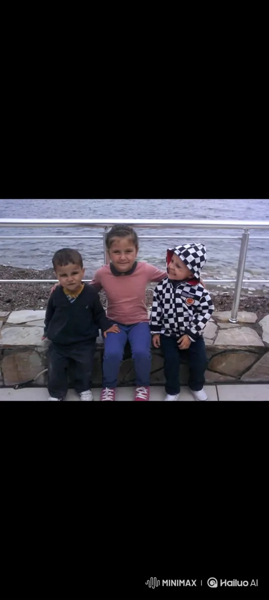 Three Children Embrace on a Stone Wall by Water – AI Generated Video | Hailuo AI