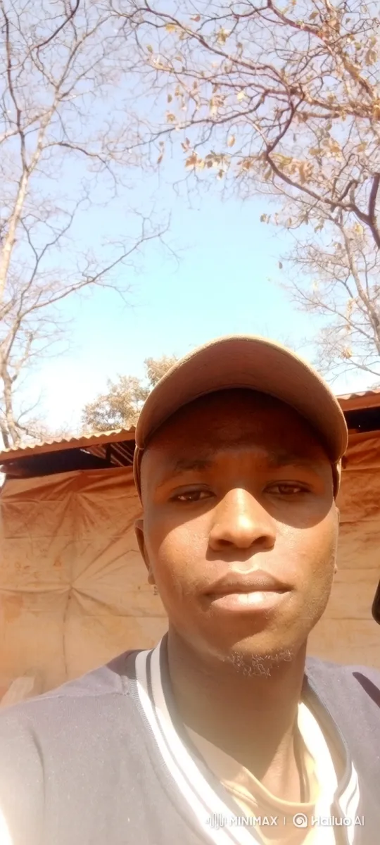 Young Man Smiles Gently Outdoors, Capturing a Serene Moment – AI Generated Video | Hailuo AI