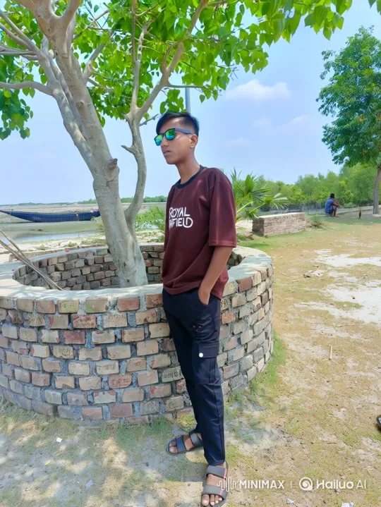 Young Man Stands by Tree in Sunny Day – AI Generated Video | Hailuo AI