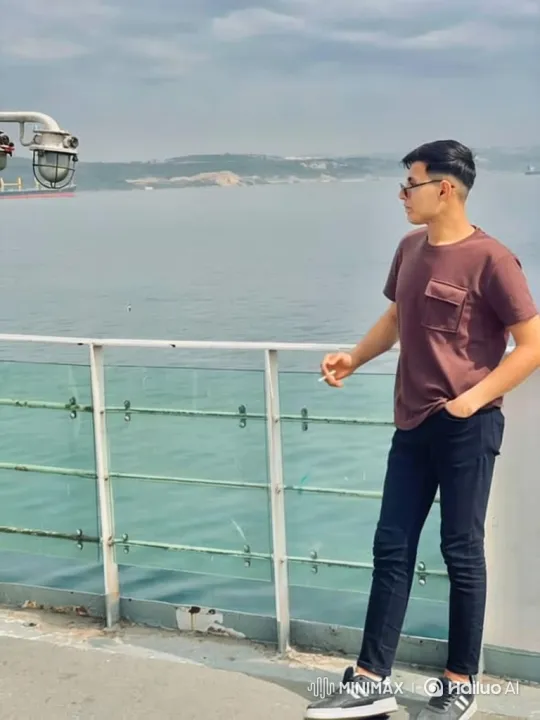 Contemplative Man on Boat in Overcast Day – AI Generated Video | Hailuo AI