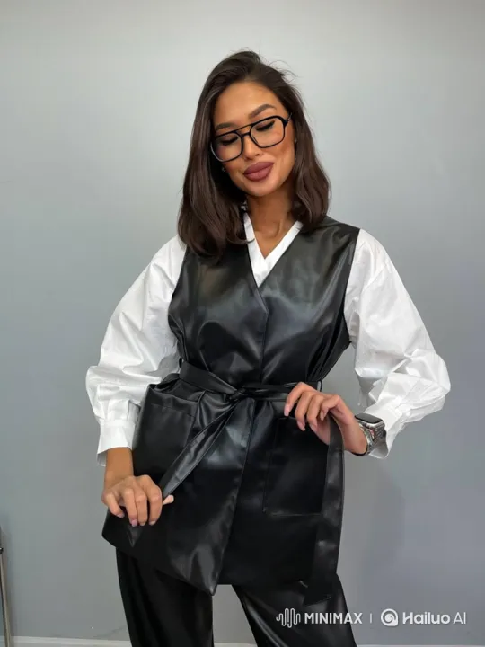 Stylish Woman Adjusts Vest in Minimalist Setting – AI Generated Video | Hailuo AI