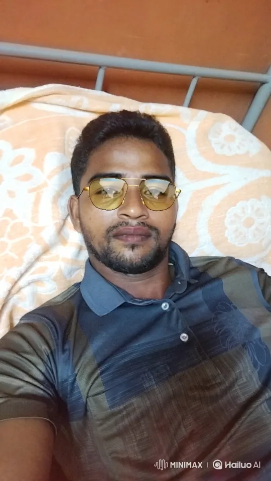 Young Man Resting on Cot in Green Paddy Field – AI Generated Video | Hailuo AI