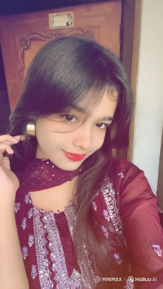 Young Woman with Embroidered Maroon Garment and Gentle Smile – AI Generated Video | Hailuo AI
