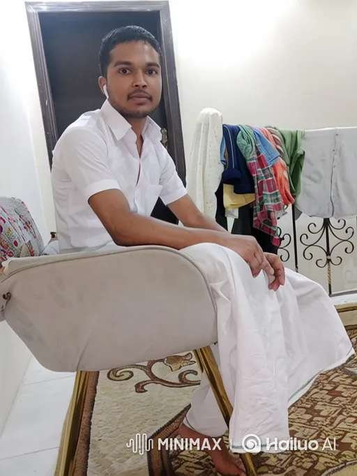Man in White Shirt Sitting, Camera Moves and Zooms In – AI Generated Video | Hailuo AI