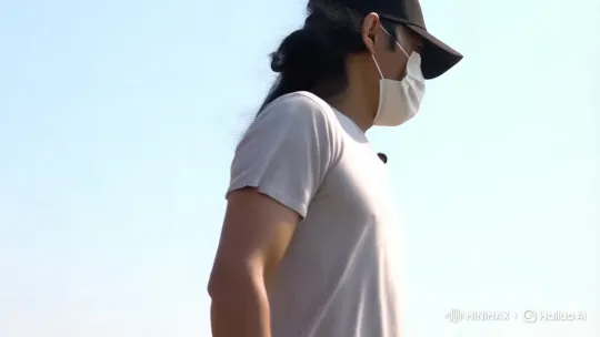 Man in Black Cap Walks with Purpose in Minimalistic Setting – AI Generated Video | Hailuo AI