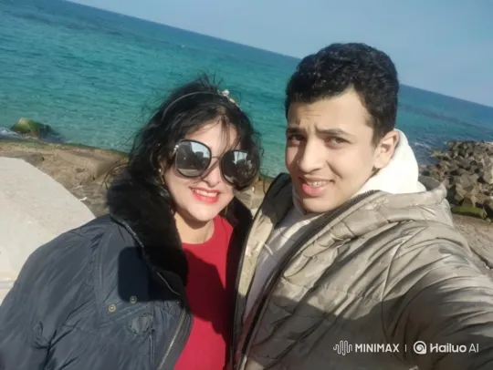 Couple Poses for Selfie by Serene Coastal Scene – AI Generated Video | Hailuo AI