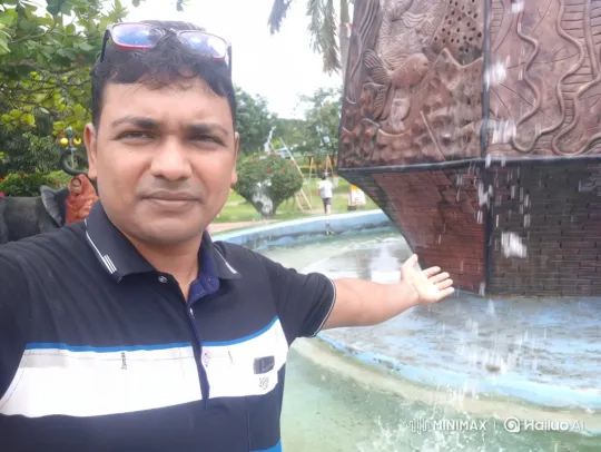 Man Enjoying Cool Mist by Ornate Fountain – AI Generated Video | Hailuo AI