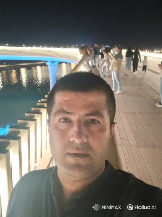 Man on Bridge: Nighttime Tracking Shot with Dynamic Camera Movement – AI Generated Video | Hailuo AI